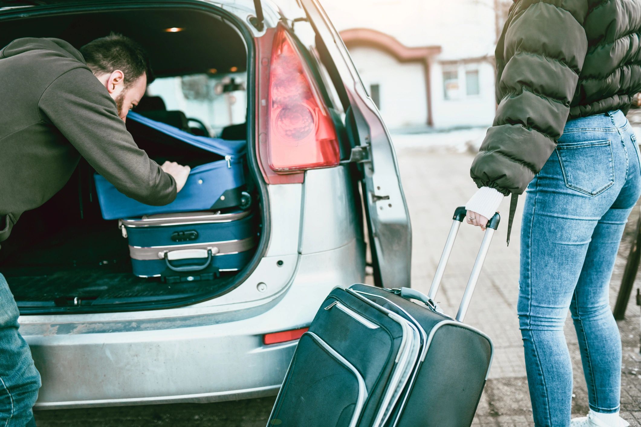 Travellers preparing luggage for a private hire car