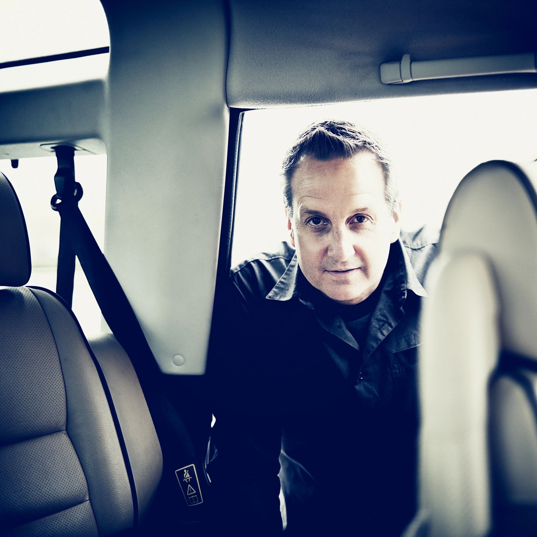 Smiling driver portrait representing airport transfers