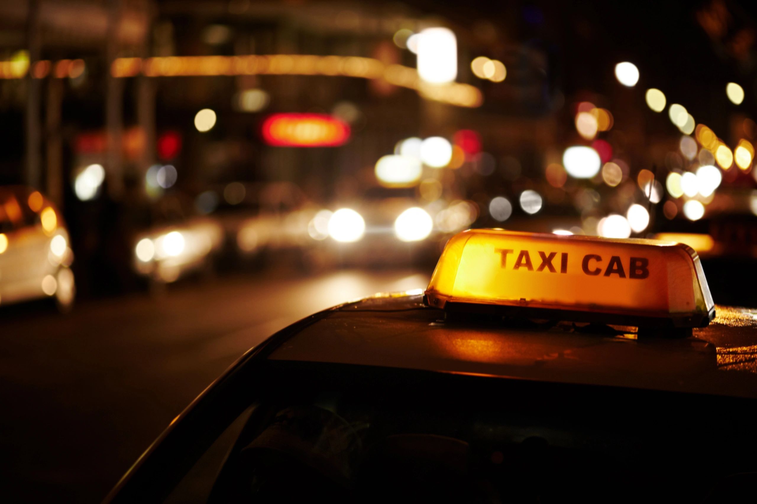 Taxi on a city street at night