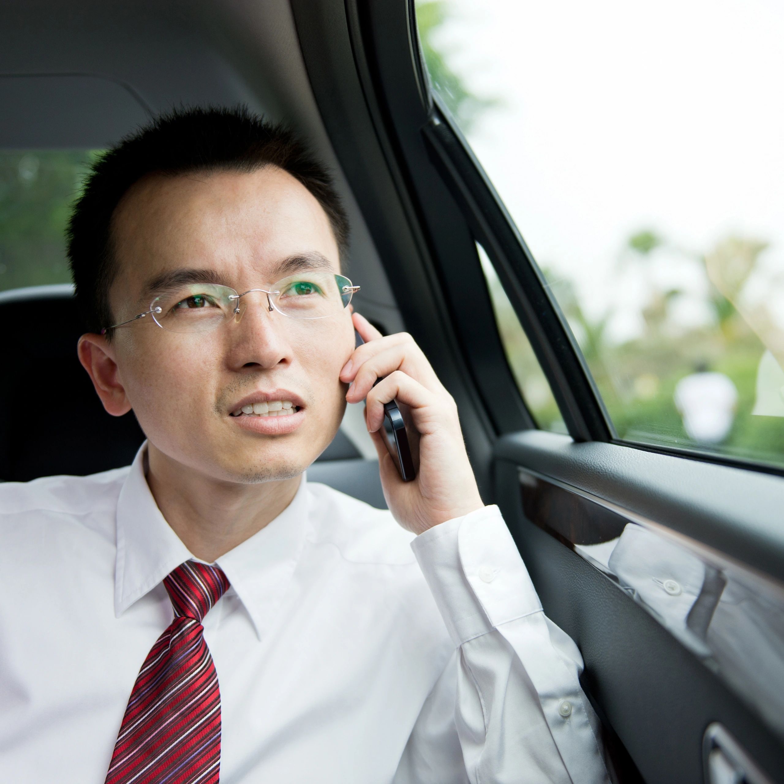 Passenger sitting in the back seat of a car