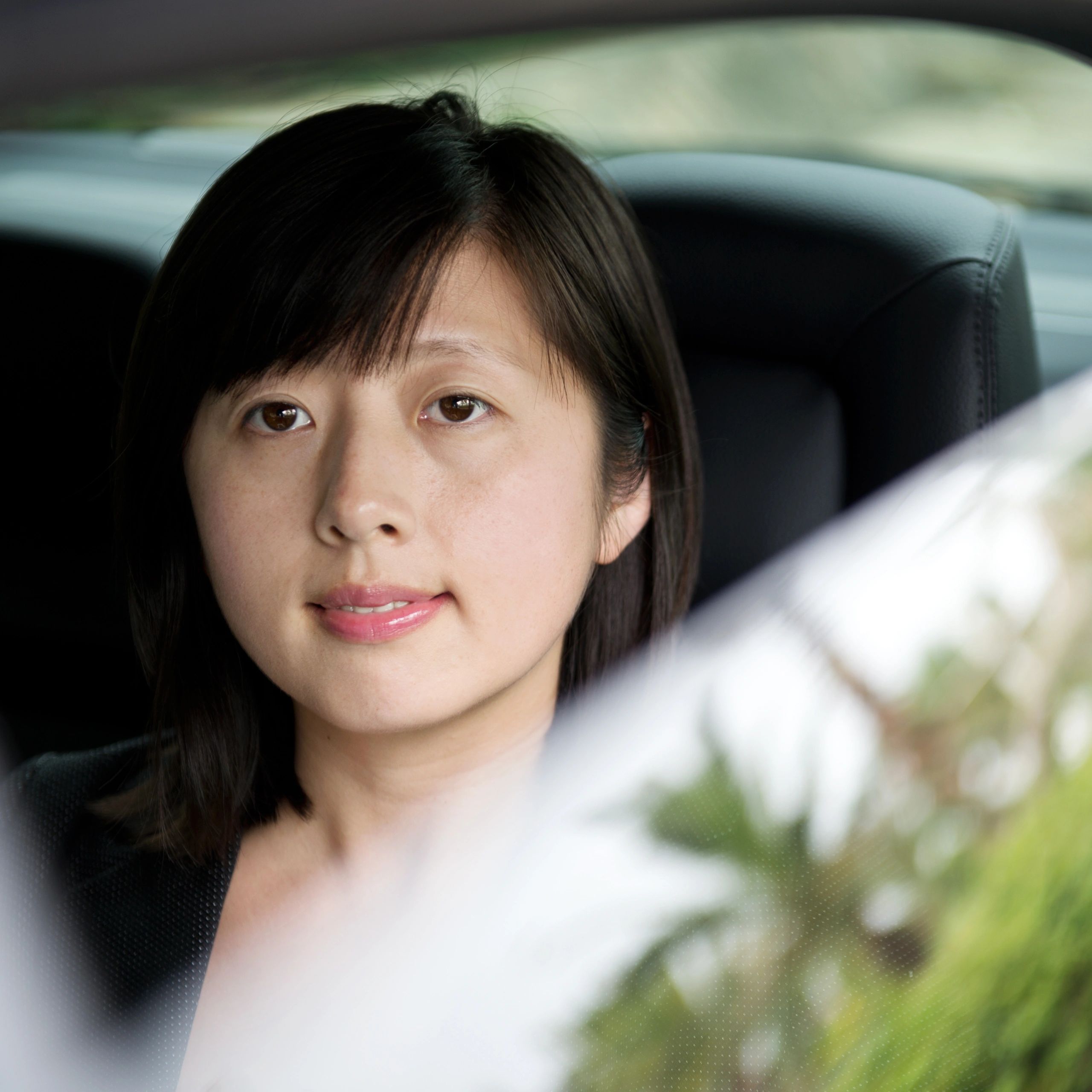 Passenger in the back seat of a car during a private hire ride